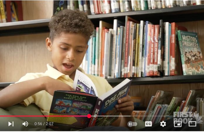  child reading on youtube video screen