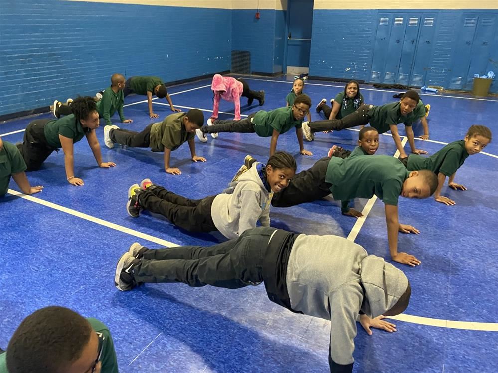  Students planking in gymnasium