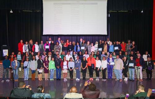  A group of students standing on stage together. 