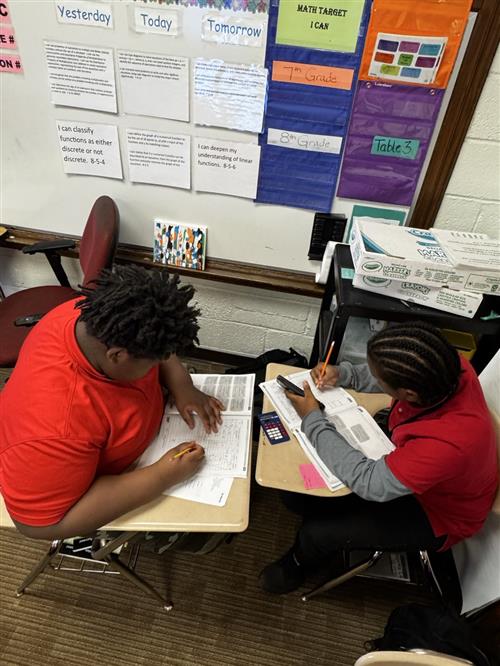 Two scholars working on problems 