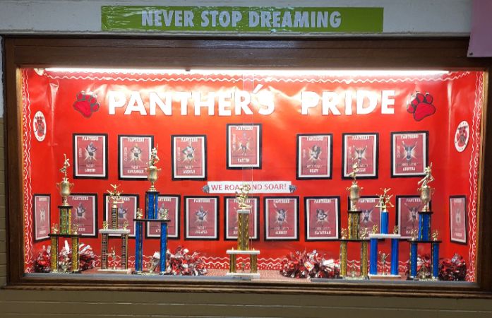 cheerleading showcase with pictures and trophies.