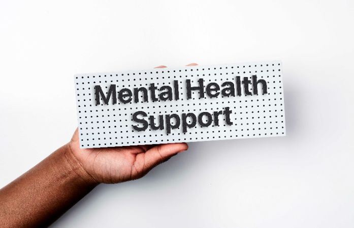 hand holding a Mental Health Support sign