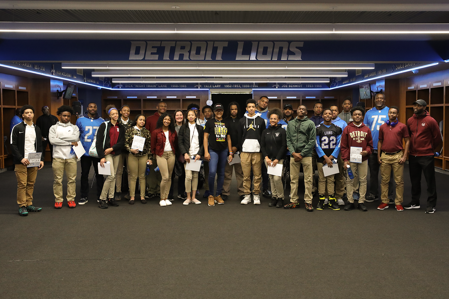 Renaissance students with Detroit Lions players in Locker Room 