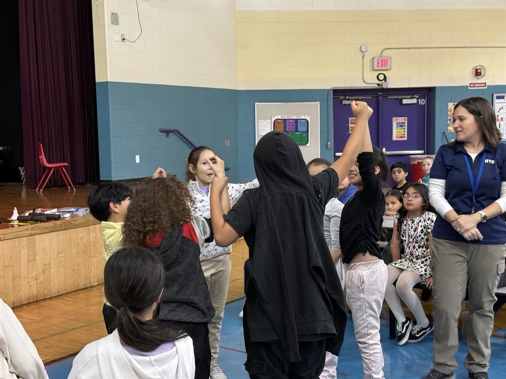 students standing in a circle holding hands 