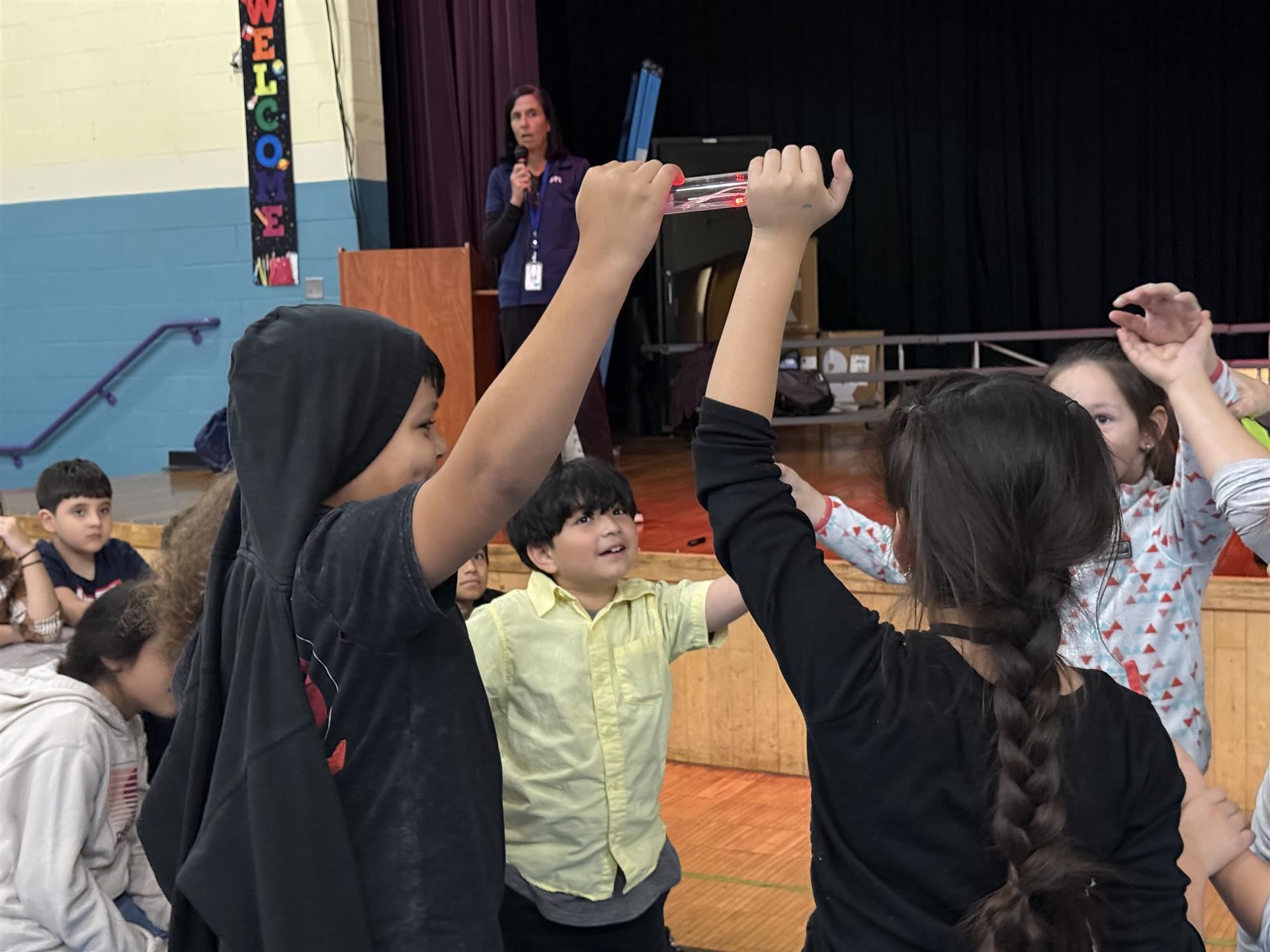 students standing in a circle holding hands 
