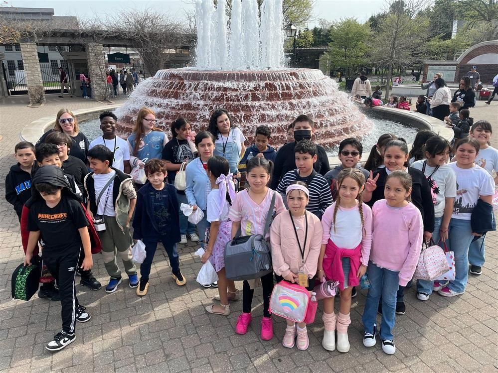  students standing in front of a fountain