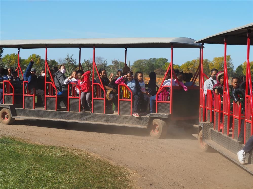  Children and teachers riding on a train.