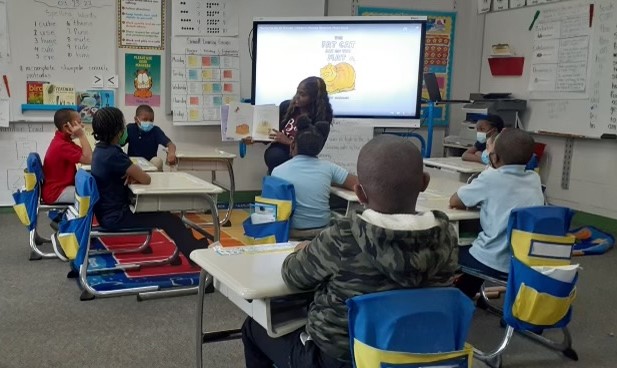  Teacher reading a story in a first grade class.