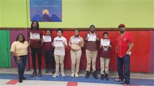 middle school students holding certificates
