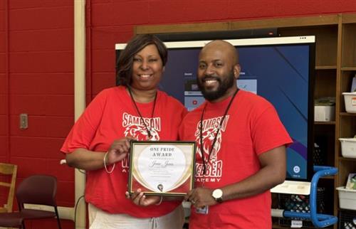  Ms. Jones receiving the One Pride Award from Mr. Farmer