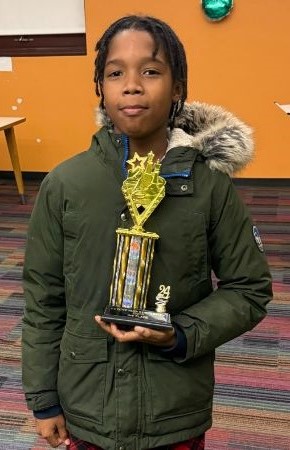 Jaden Woods holding 3rd Place trophy