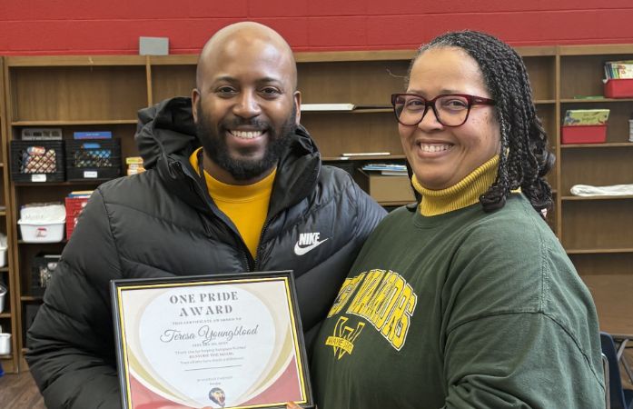 Principal Farmer presenting Mrs. Youngblood with the One Pride Award