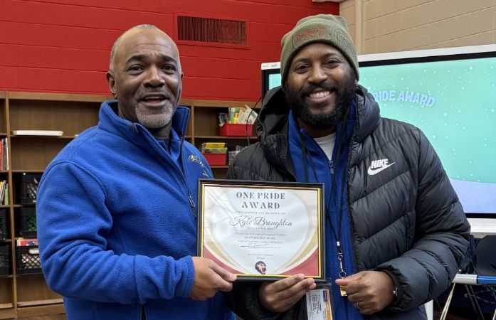 Mr. Broughton receiving award from princpal