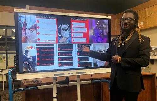 senior presenting capstone project on a smartboard
