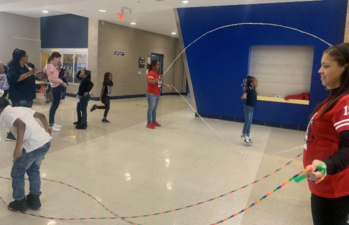 Students jumping rope with the 40 and over Double Dutch Team