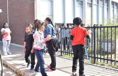 Students receiving their ice cream from the ice cream truck