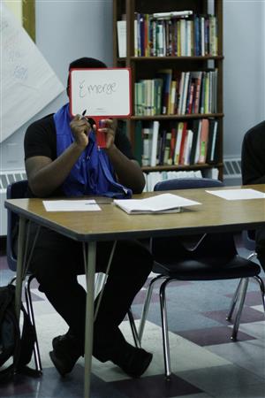 Student holding up whiteboard 