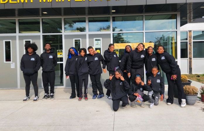  Students posing in front of school