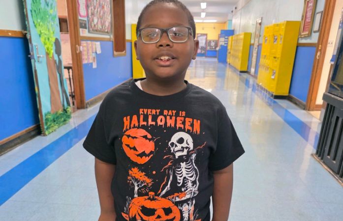  Student smiling in halloween shirt