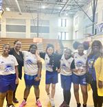 Girl basketball players with principal and coach