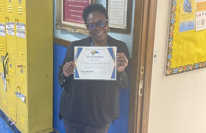  ms. henderson standing in front of office