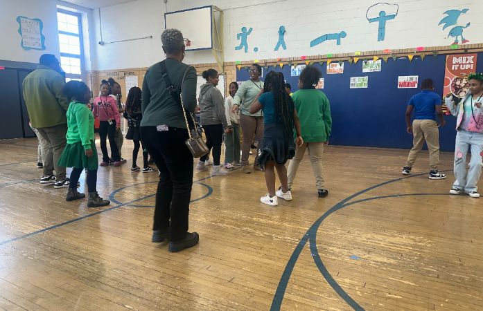  students and teachers dancing