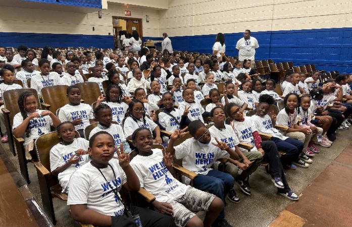  students sitting in school auditorium