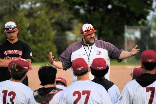  Image of Varsity Boys baseball coach speaking to his team after the game.