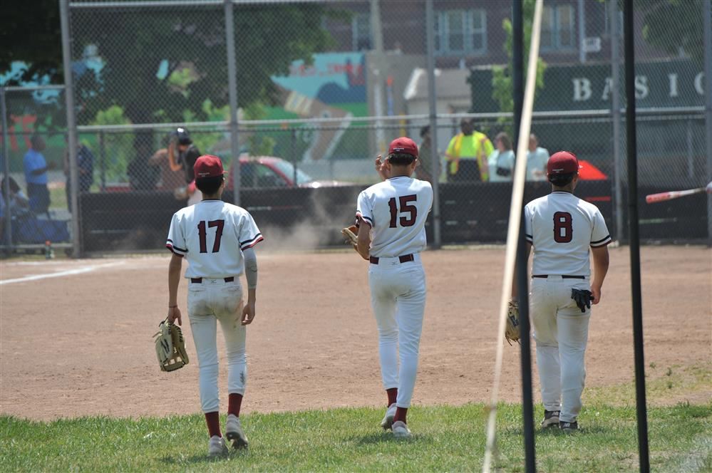  Three Western Baseball players walking in from the outfield