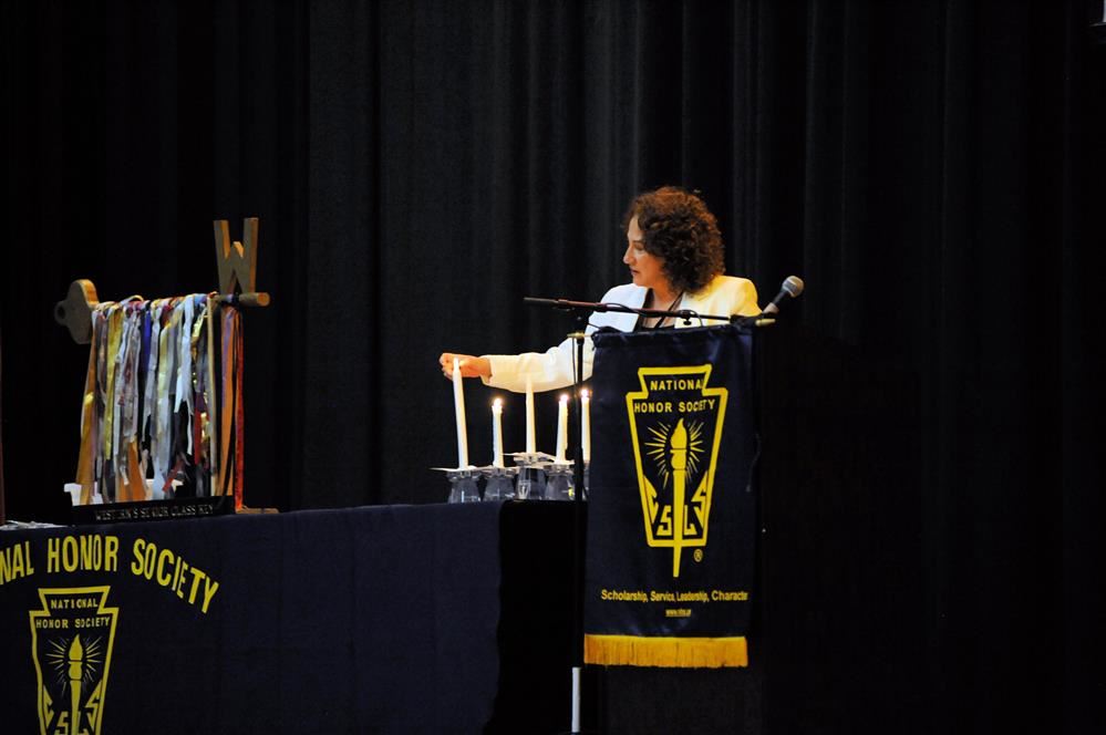  Ms. Tara Baker lighting the candle representing leadership.