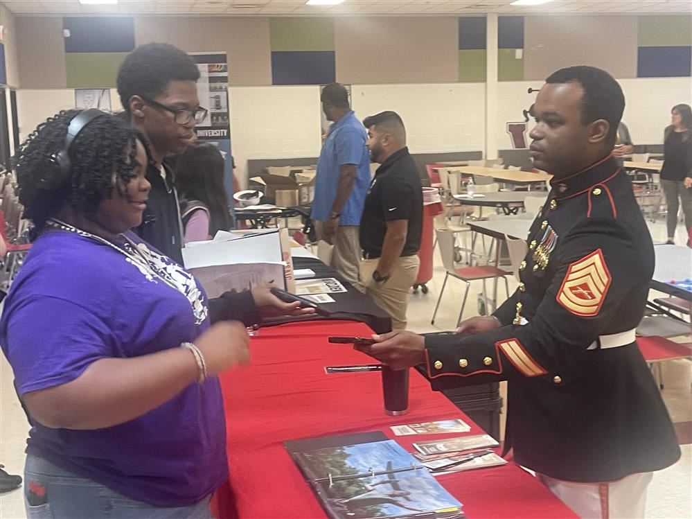  Two Western students talking to a vendor at the college and career fair