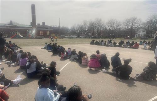 students looking up at the sun