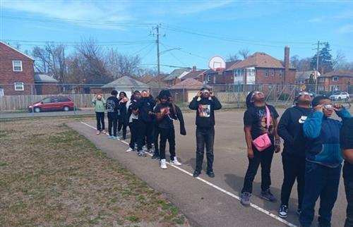 students looking up at the sun