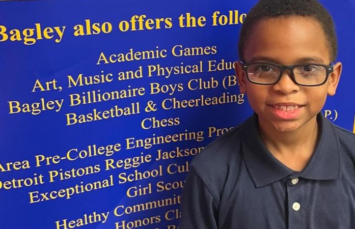  student wearing a new pair of glasses provided by vision and hearing