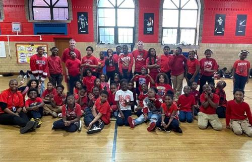  staff and students taking a picture in read ang