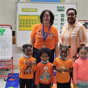 children dressed in orange