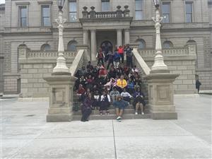  Students sitting on the Michigan State Capitol steps.