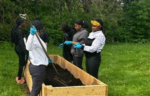 students gardening.