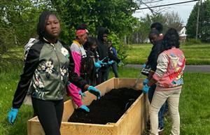 students gardening.