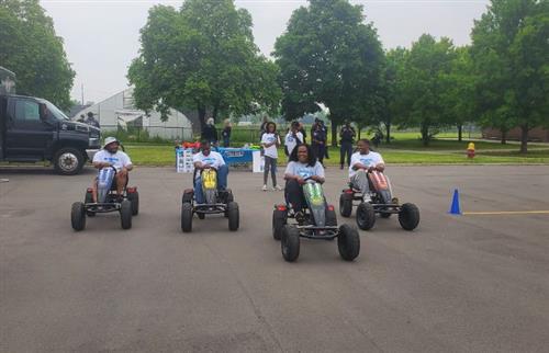  4 people riding go-carts