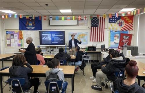 Man standing in from of the class speaking to students