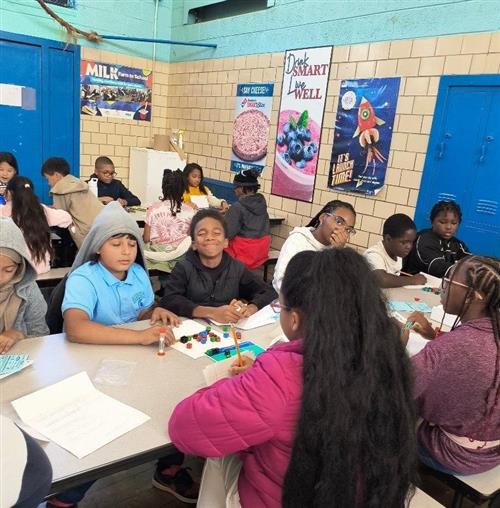 Several players from the Chrysler/Bunche Academic games team playing the game Equations