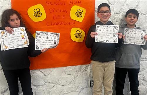  Students posing with there winning certificates.