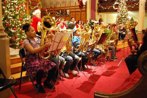 bethune students sitting front row with tubas for a Very Tuba Christmas 