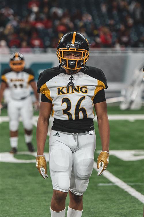 King Crusader Football Teamp Player number 36 walking on field 