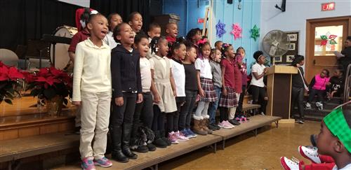 1st grade singing We Wish You A Merry Christmas 
