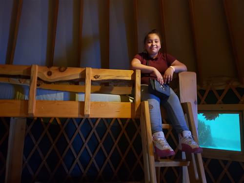 smiling on bunk beds in a cabin 