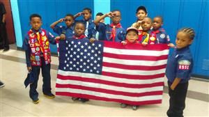 Boy Scouts holding an American flag. 