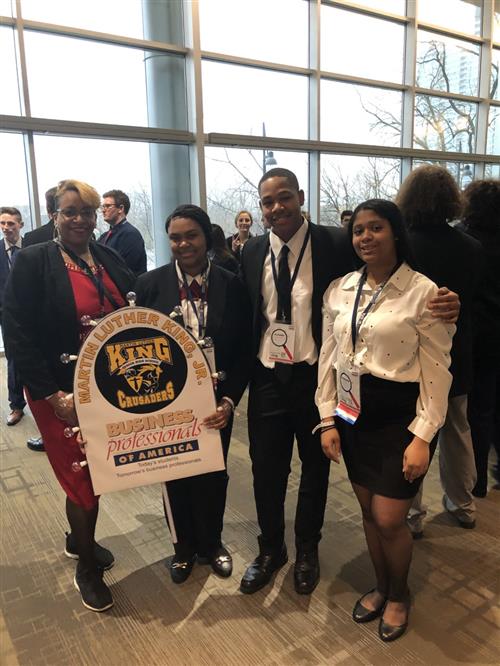 Business Professionals of America King Students at State Competition, holding King Crusader sign to represent school. 
