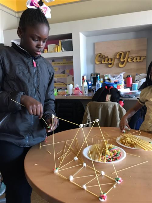 Student builds her bridge with spaghetti noodles and marshmellows 